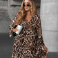 Elegante jurk met V-hals, lange mouwen en print
